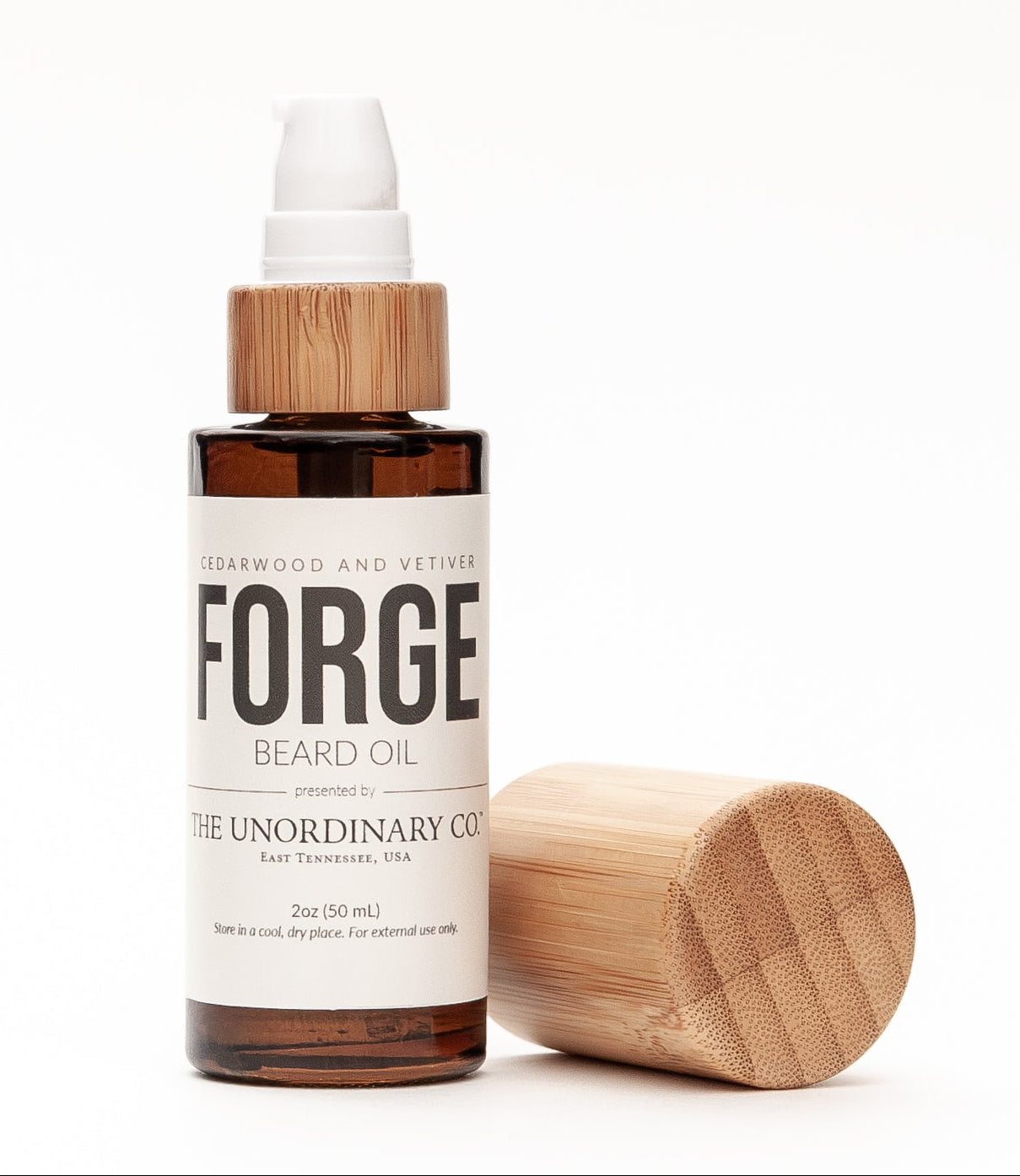 Bottle of Forge beard oil with wooden cap on a white background